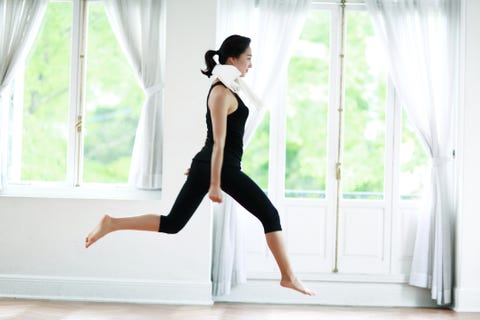 Young woman jumping at home