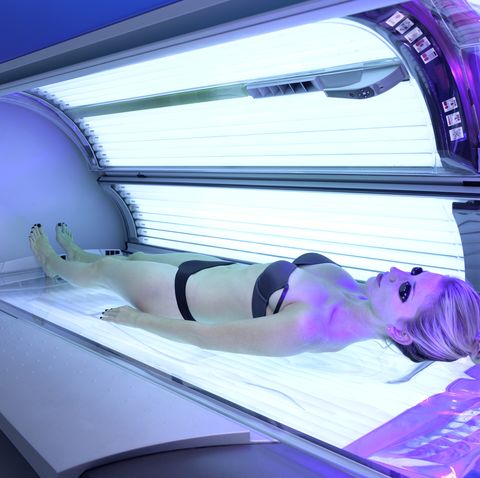 Young woman laying on sunbed