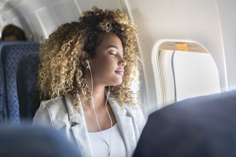 Young woman napping during flight