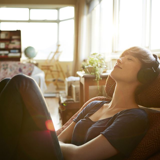 Young woman relaxing with headphones at home
