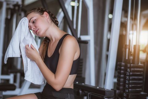 young woman resting at gym