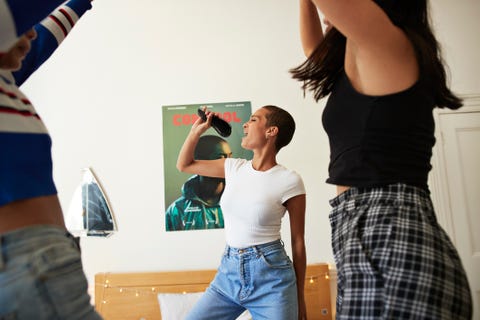 young woman singing and dancing with friends