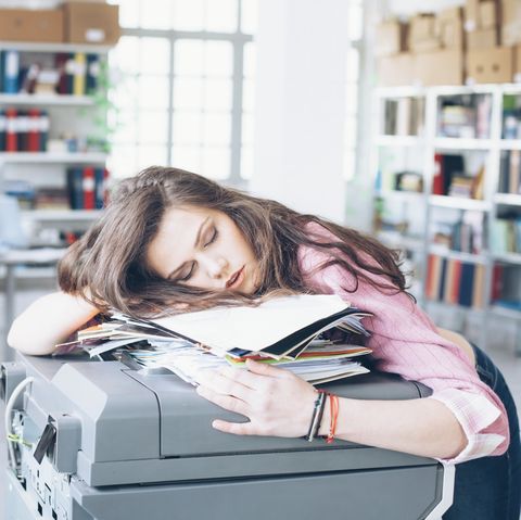 Young woman sleeping in office