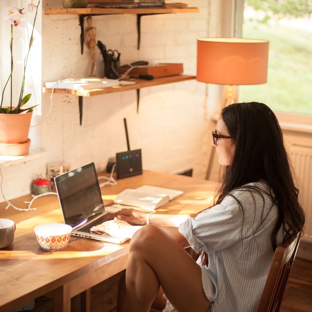Young Woman Using Laptop At Home