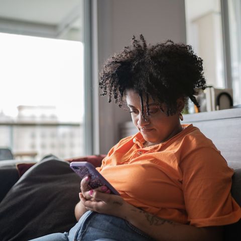 young woman using smartphone at home