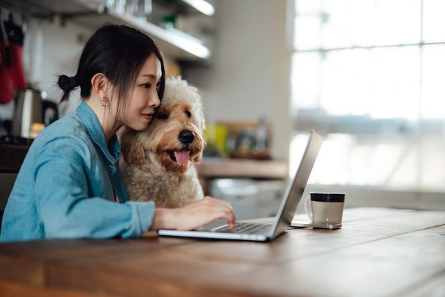 young woman working from home with her dog