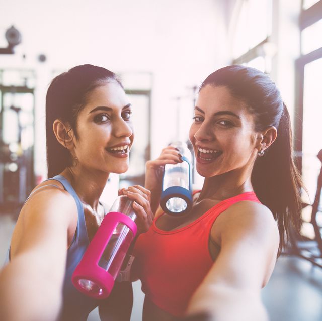 Young women taking selfies at gym after workout