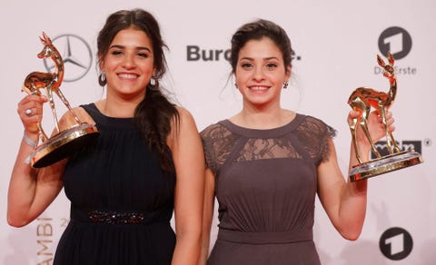 syrian refugees and swimmers yusra and sarah mardini pose for photographers with the trophy at the bambi awards on november 17, 2016 in berlin   the bambis are the main german media awards photo by axel schmidt  afp photo by axel schmidtafp via getty images