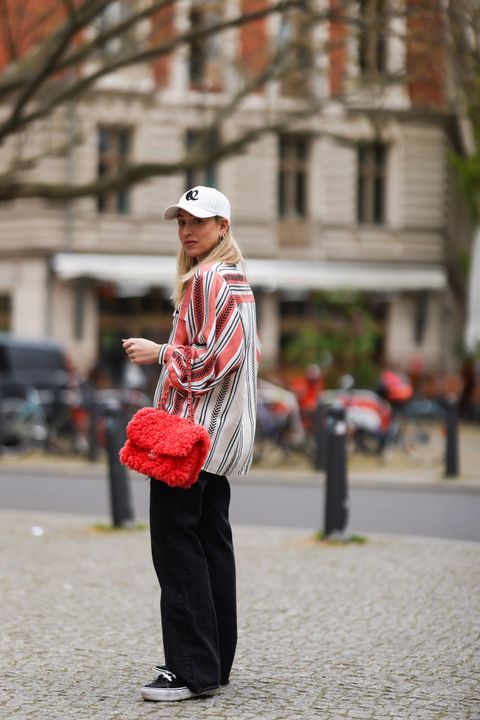 berlin, germany may 06 sonia lyson wearing lala berlin cap and flanell, orange fluffy chanel bag, black vans sneakers and black zara destroyed jeans on may 06, 2021 in berlin, germany photo by jeremy moellergetty images