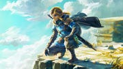 the legend of zelda tears of the kingdom key art, showing link with a cape crouched overlooking a mountain