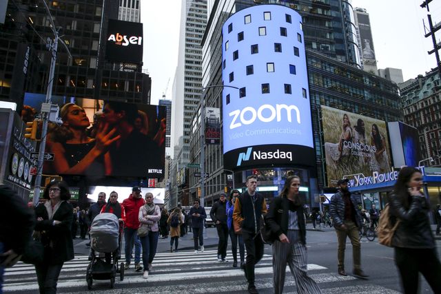 new york, ny   april 18  people pass walk by the nasdaq building as the screen shows the logo of the video conferencing software company zoom after the opening bell ceremony on april 18, 2019 in new york city the video conferencing software company announced it's ipo priced at $36 per share, at an estimated value of $92 billion photo by kena betancurgetty images