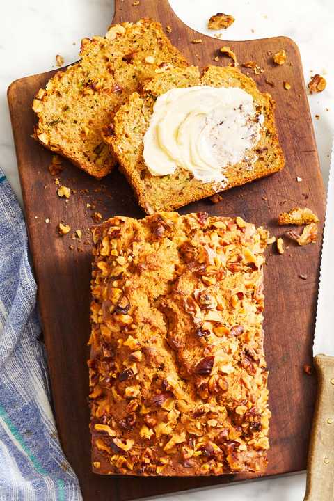 zucchini bread with butter on a wooden slab