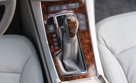 Motor vehicle, Brown, Center console, Car seat, Gear shift, Vehicle door, Luxury vehicle, Car seat cover, Vehicle audio, Steering part, 
