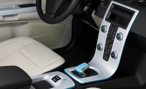 Car seat, Vehicle door, Fixture, Car seat cover, Luxury vehicle, Steering part, Gear shift, Center console, Head restraint, Multimedia, 
