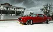 1969 red chevy camaro in front of burger joint