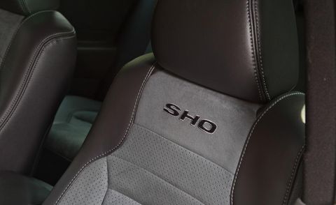 Car seat, Head restraint, Car seat cover, Leather, Vehicle door, Luxury vehicle, Seat belt, Carbon, 