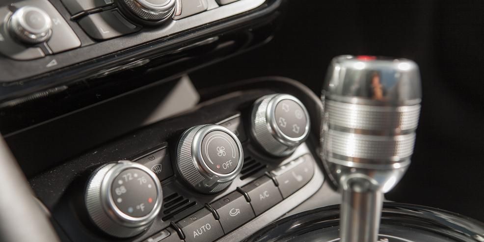 Center console, Gear shift, Personal luxury car, Metal, Vehicle audio, Machine, Luxury vehicle, Silver, Steel, Still life photography, 