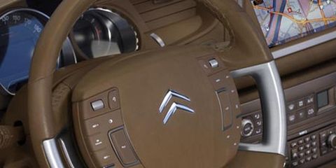 Motor vehicle, Mode of transport, Brown, Steering part, Steering wheel, Car, Luxury vehicle, Personal luxury car, Technology, Center console, 