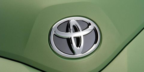 Motor vehicle, Automotive design, Green, Daytime, Automotive exterior, Symbol, Logo, Font, Emblem, Teal, 