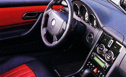 Motor vehicle, Mode of transport, Steering part, Automotive design, Steering wheel, Red, Center console, Car, Luxury vehicle, Personal luxury car, 