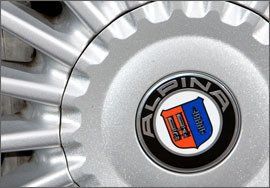 White, Logo, Grey, Alloy wheel, Metal, Symbol, Automotive wheel system, Circle, Steel, Black-and-white, 