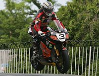 Motorcycle, Motorcycle helmet, Motorcycling, Motorcycle racing, Motorcycle racer, Sports gear, Motorsport, Personal protective equipment, Helmet, Competition event, 