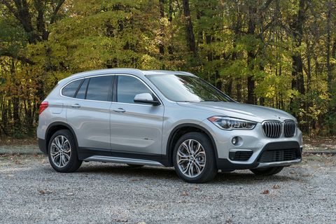 2017 silver bmw x1 suv parked near trees