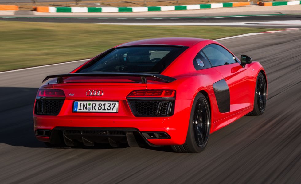 2017 red audi r8 towards a curve in a racetrack