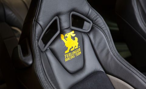 Car seat, Logo, Leather, Vehicle door, Luxury vehicle, Car seat cover, Carbon, Steering part, Steering wheel, Head restraint, 