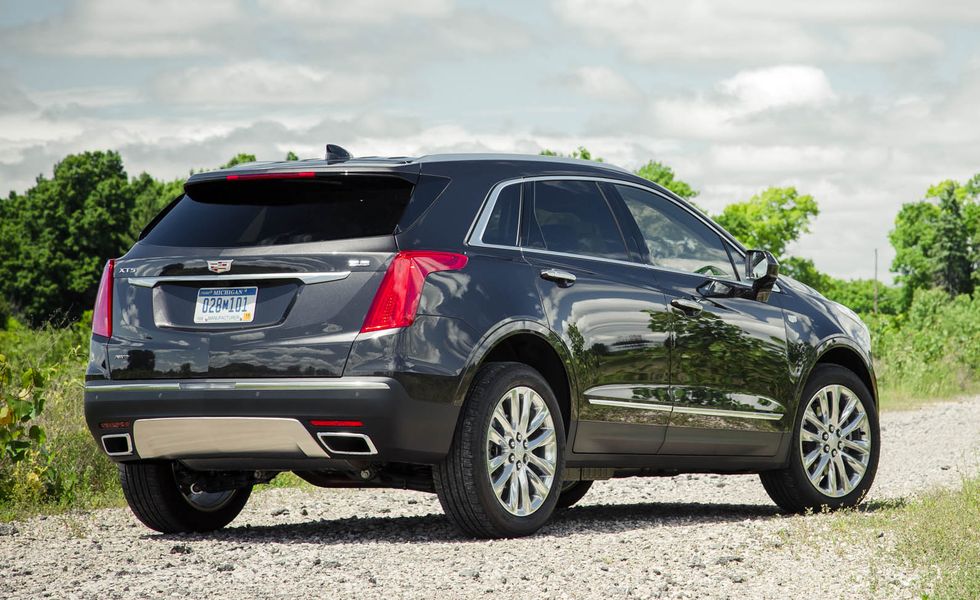 2017 black cadillac xt5 suv parked on a gravel road