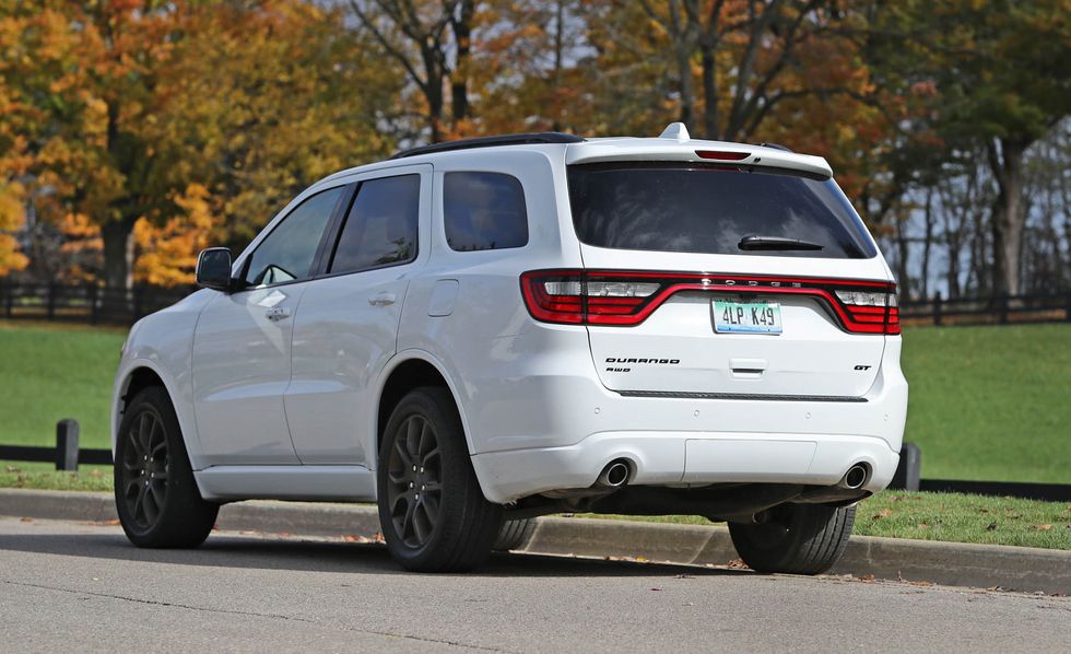 2017 white dodge durango suv parked near a park clearing