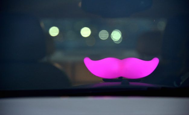 Lyft mustache logo seen in car window