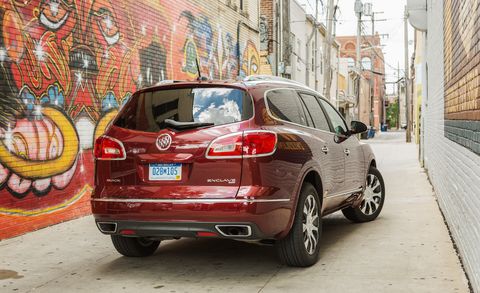 2017 maroon buick enclave suv parked in an alley with a mural painted on one side