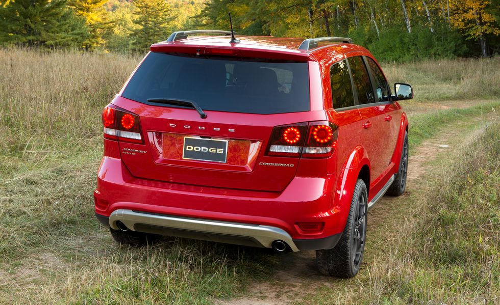 2017 red dodge journey suv on a trail near a wheat field