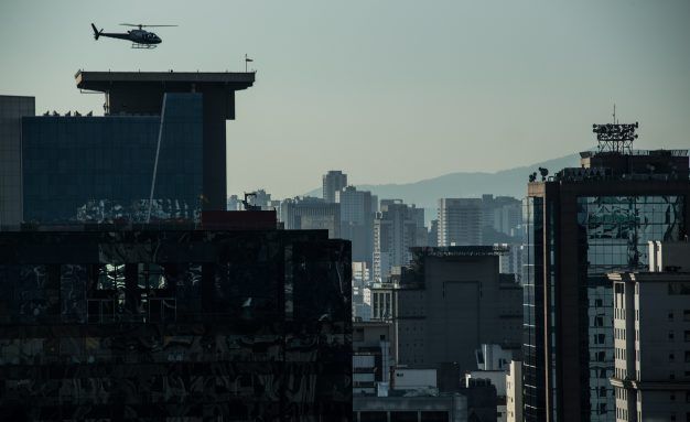 A helicopter lands on the roof of a building in downtown Sao Paulo, Brazil on June 23, 2017. Airbus' subsidiary Voom gives an alternative for those willing to avoid Sao Paulo's heavy car traffic, offering a helicopter service similar to the car service offered by Uber. Sao Paulo counts one car every two inhabitants and during rush time there are between 330 and 576 km of traffic jams. 