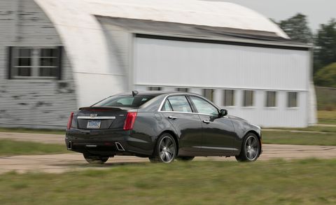 2017 cadillac cts sedan driving near small airplane hangar