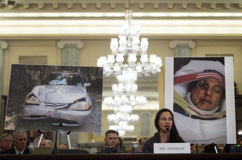 Air Force Lt. Stephanie Erdman, whose eye was injured by airbag shrapnel from her 2002 Honda Civic, is surrounded by pictures showing the accident as she testifies before the US Senate Committee on Commerce, Science, and Transportation on Capitol Hill in Washington, DC, November 20, 2014, on the Takata airbag defects and the vehicle recall process. 