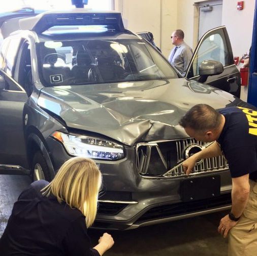 Investigators from the National Transportation Safety Board examine the Volvo XC90 which struck a pedestrian in Tempe, Arizona, on Sunday night.