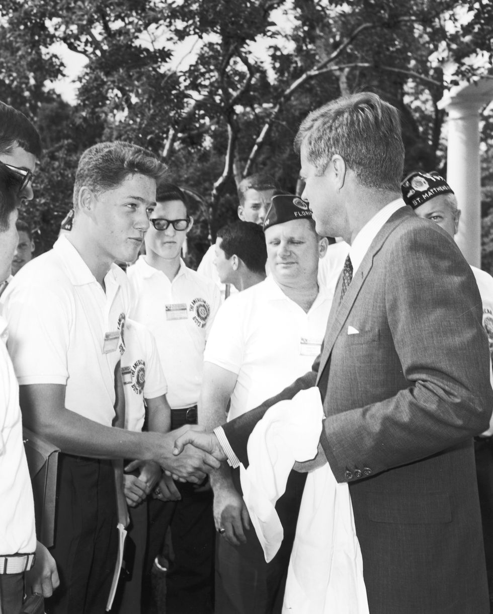 Bill Clinton, a teenage boy, shakes the hand of President John F. Kennedy