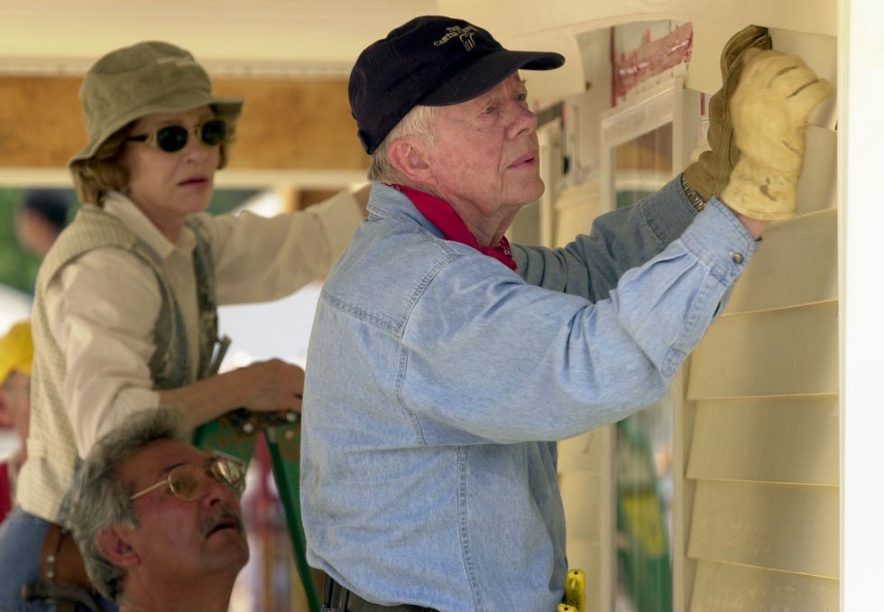 jimmy carter and his wife, rosalynn, attach siding to the front of a habitat for humanity home being built june 10, 2003, in lagrange, georgia
