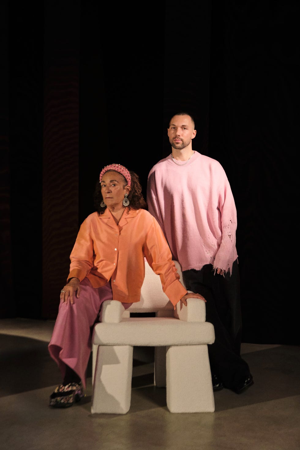 a man and woman sitting on a bench