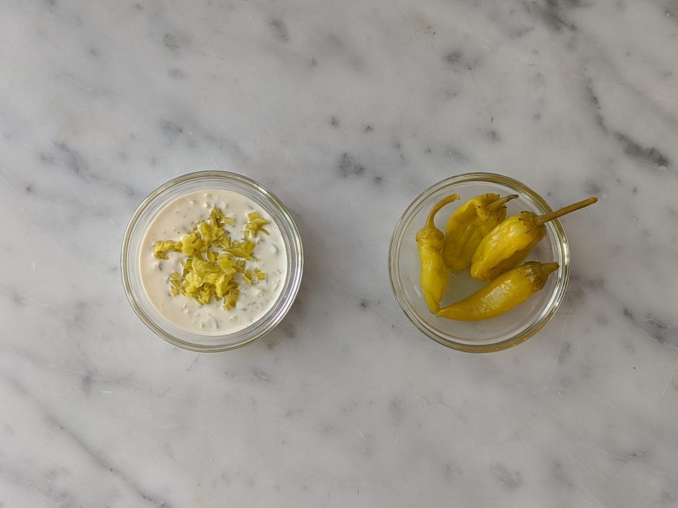 pepperoncini mayo next to bowl of pepperoncini