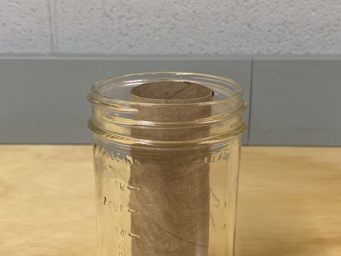 fitting the paper towel tube in the mason jar