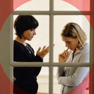 mother and daughter talking in a window