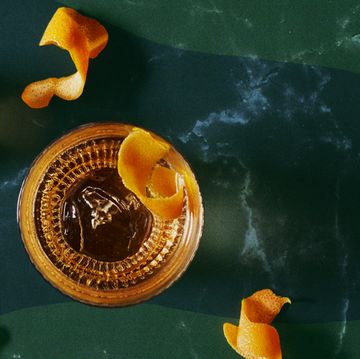 overhead view of cocktail with nuts and lemon peel