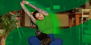 a woman stretching and mediating with a cat in her lap