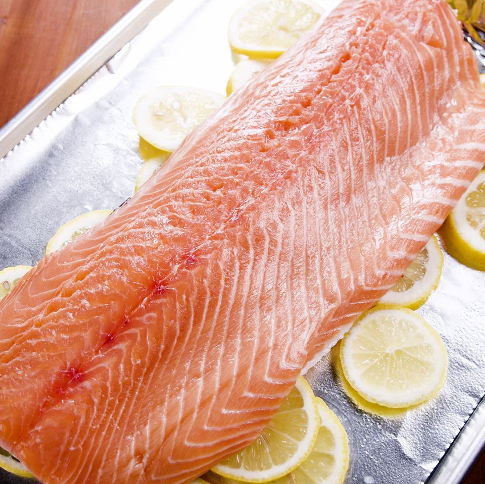 a sheet tray with salmon and lemons