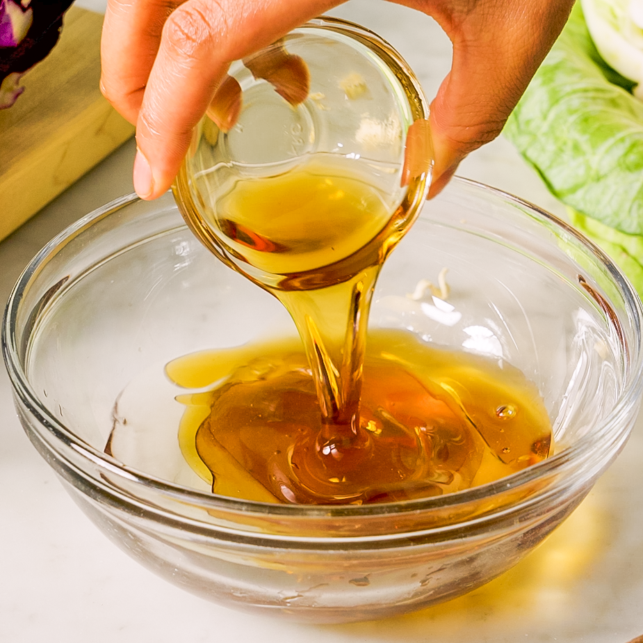 making a dressing in a glass bowl