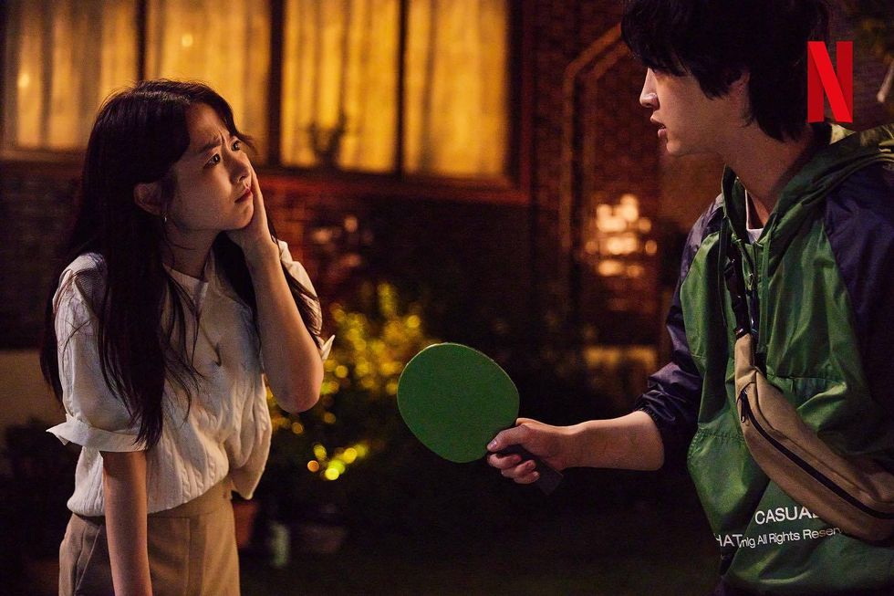 a man and a woman holding a green frisbee