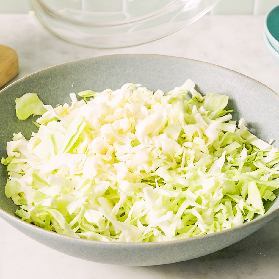 shredded green cabbage in a bowl